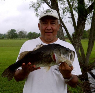 Tony Oviedo holds a nice bass caught from the shore at Matagorda Ashwood Palms.