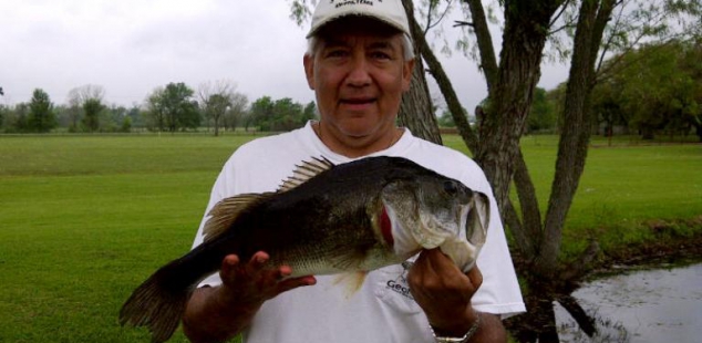 Tony Oviedo holds a nice bass caught from the shore at Matagorda Ashwood Palms.